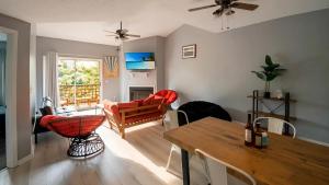 a living room with a table and a couch at Corporate Retreat - Stylish 2BR Condo with Pool, Balcony & Fast Wi-Fi, Minutes from Downtown Wilmington in Wilmington