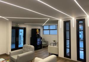 a living room with white furniture and windows at Hotel Yolima Real in Bogotá