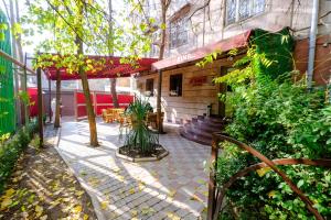 a patio with a table and chairs and a building at Time Boutique Hotel in Yerevan