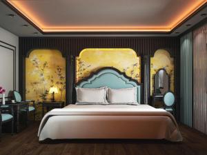 a bedroom with a large bed with a painting on the wall at Villa Victoria Me Tri in Hanoi