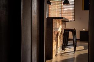 a fireplace in the middle of a room with a stool at bamboo宮古島 in Miyako-jima