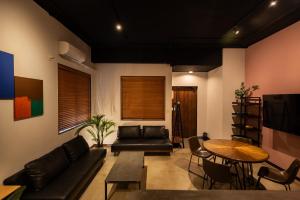 a living room with a couch and a table at bamboo宮古島 in Miyako-jima
