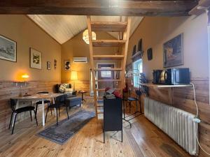 a living room with a table and a dining room at Daltorps skola - self check in in Skövde