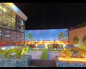 a restaurant with tables and chairs in front of a building at Mitanvi the heaven in Ujjain