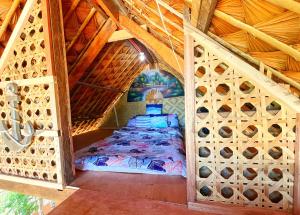 a bedroom with a bed in a wooden attic at Ālon in Linukso +3 photos