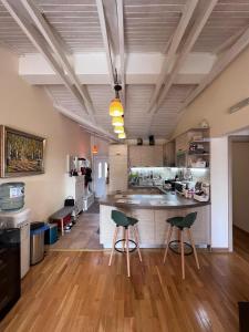 a large kitchen with two chairs and a table at SUNTIME apartament 5 in Kotor