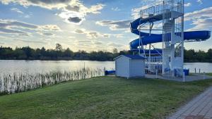a water slide on the side of a lake at Relax Vendégház in Dunapataj