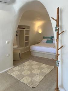a bedroom with a bed with a cross on it at Naya seaside apartment in Firopótamos