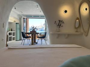 a bedroom with a bed with an elephant head on the wall at Naya seaside apartment in Firopótamos +12 photos
