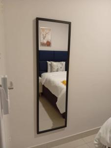 a mirror on a wall next to a bed at Amos in Gaborone +9 photos