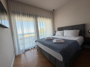 a bedroom with a bed and a large window at Villa MIO in Bar +17 photos