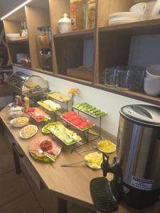 a table with many plates of food on it at Willa AGAT in Ciechocinek