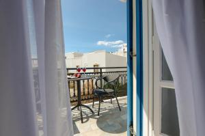 a view from a balcony with a table and chairs at Naxos Diol in Naxos Chora