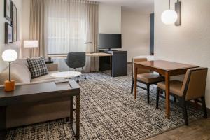 a hotel room with a couch and a table at Residence Inn Columbia in Columbia