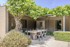 a table and chairs under a tree on a patio at Thule Country Estate - Private Architect-Designed Farm Estate, 6 Bedrooms, Sleeps 12 in Mount Macedon +32 photos