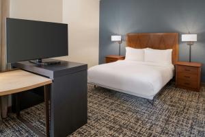 a bedroom with a bed and a flat screen tv at Residence Inn Columbia in Columbia +28 photos