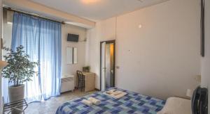 a bedroom with a bed and a large window at Hotel Continental in Pesaro