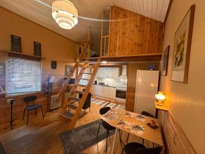 a living room with a staircase and a kitchen at Daltorps skola - self check in in Skövde +13 photos