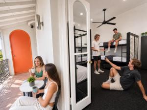 a group of people in a room with bunk beds at London Gate Backpackers Hostel in Sydney