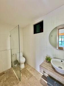 a bathroom with a toilet and a sink and a mirror at Luxury Apartment top location! in Playa del Carmen