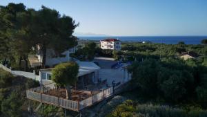 a house on a hill with the ocean in the background at Zante View Studios & Villas in Tsilivi