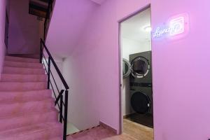 a staircase with a pink wall and a washing machine at Luxury Apartment top location! in Playa del Carmen