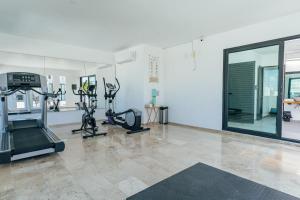 a gym with treadmills and exercise bikes in a room at Luxury Apartment top location! in Playa del Carmen +7 photos