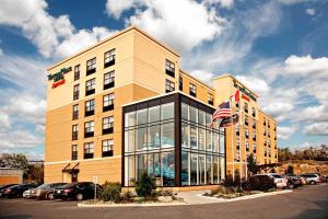 a building with an american flag in front of it at TownePlace Suites by Marriott Sudbury in Sudbury