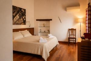 a bedroom with a bed with two towels on it at Boutique Rooms 3 0 in Ferrara