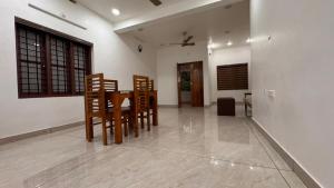 a dining room with a table and chairs in a room at Souparnika apartments in Varkala +23 photos