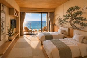 two beds in a room with a view of the ocean at 카미소 in Tsushima