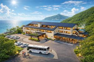 a bus parked in front of a building next to the ocean at 카미소 in Tsushima