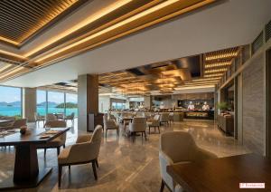 a restaurant with tables and chairs and a bar at 카미소 in Tsushima