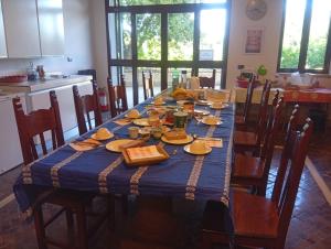 a dining room table with a blue table cloth on it at Casa Yoga 2 Rilassati in una oasi di pace immersa nella natura a soli 60 minuti da Roma in Bassano Romano