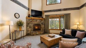 a living room with a couch and a fireplace at BOTHR Steelhead in McCall