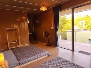 a bedroom with a bed in the middle of a room at La An Homestay in Vĩnh Hy