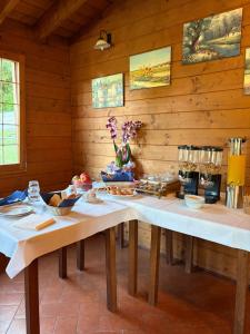 a kitchen with two tables in a wooden room at Alta Quiete in Frontone +31 photos