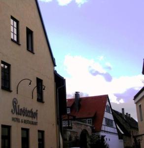 a city street with buildings and a blue sky at Hotel & Restaurant Klosterhof in Dresden