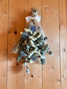 a wreath is hanging on a wooden wall at ウバク荘 Ubakuso in Biei