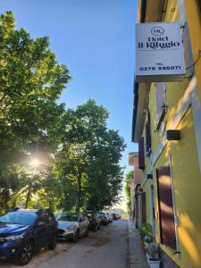 a street with cars parked on the side of a building at Hotel IL Rifugio in Gonzaga