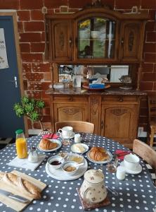 a table with a blue and white polka dot table cloth at Gradine et Boucharde in Le Monastier sur Gazeille