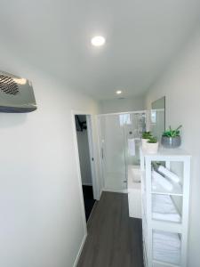 a bathroom with a sink and a shower at Queenstown Studio with Mountain Views in Frankton +10 photos