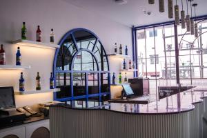 a room with a bar with a desk with a laptop at Hotel PRD Palace in Saharsa