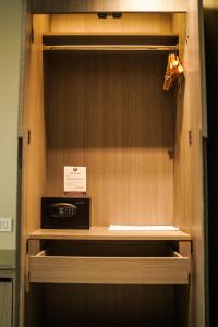 a cabinet with a microwave on top of it at Hotel PRD Palace in Saharsa