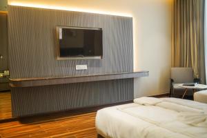 a hotel room with a bed and a flat screen tv at Hotel PRD Palace in Saharsa +18 photos