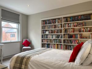 a bedroom with a book shelf filled with books at Victoria Apartment 1 in Tarporley +7 photos