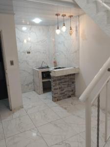 a bathroom with a sink and a brick fireplace at Hermoso apartamento in Soledad