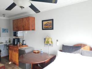 a kitchen with a table and a small kitchen with a couch at Rosa Villa in Hermanus