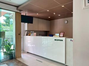 a kitchen with a reception counter in a building at S3 Residence Park in Bangkok