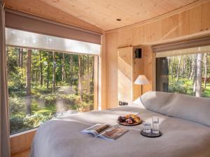 a bed in a room with a large window at Kanna-Qu7625 in Chipping Norton